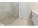 Bathroom showcasing tile shower with glass door and white vanity at 2192 Seagrass Pt # 427, Kissimmee, FL 34747