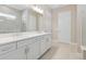 Bathroom featuring double sinks, modern lighting, and walk-in shower at 2192 Seagrass Pt # 427, Kissimmee, FL 34747