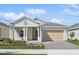 Charming single-story home with a well-manicured lawn, inviting porch, and a two-car garage at 2192 Seagrass Pt # 427, Kissimmee, FL 34747