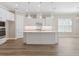 Bright kitchen featuring white cabinets, a large island, pendant lighting, and modern appliances at 2192 Seagrass Pt # 427, Kissimmee, FL 34747