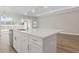 Close up of an island with stainless steel appliances and light wood flooring at 2192 Seagrass Pt # 427, Kissimmee, FL 34747