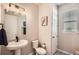 Powder room featuring a pedestal sink, modern fixtures, and a window with blinds at 2277 Crossbow St, Clermont, FL 34715