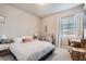 Bright bedroom featuring a comfortable queen-size bed, a dedicated desk space, and a cozy reading nook at 2277 Crossbow St, Clermont, FL 34715