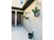 A cozy entrance with hanging potted plants and neutral-colored walls, next to an entrance door at 2285 Seven Oaks Dr, St Cloud, FL 34772