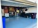 Spacious garage with blue epoxy floors, storage solutions, and ample room at 2285 Seven Oaks Dr, St Cloud, FL 34772