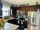 An inviting kitchen with dark cabinetry, stainless steel appliances, and granite countertops at 2285 Seven Oaks Dr, St Cloud, FL 34772