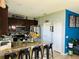 Eat-in kitchen with granite counters, stainless appliances, and a blue accent wall at 2285 Seven Oaks Dr, St Cloud, FL 34772