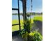 Screened-in patio overlooking the lake with various plants and hanging decorations at 2285 Seven Oaks Dr, St Cloud, FL 34772