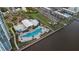 Aerial view showcasing the community pool, surrounding greenery, and waterfront location at 231 Riverside Dr # 708, Daytona Beach, FL 32117