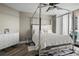 Modern bedroom features a stylish four-poster bed, sleek dresser, and stunning city views at 231 Riverside Dr # 708, Daytona Beach, FL 32117
