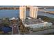 An aerial view shows two condo buildings with a parking garage and landscaping and waterfront at 231 Riverside Dr # 708, Daytona Beach, FL 32117