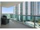 Spacious balcony featuring clear views of high-rise buildings and tropical palm trees at 231 Riverside Dr # 708, Daytona Beach, FL 32117