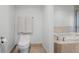 Bright bathroom featuring a modern toilet and a soaking tub with beige tiled accents at 231 Riverside Dr # 708, Daytona Beach, FL 32117