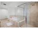 Bright bathroom featuring a soaking tub, separate glass shower, and tile flooring at 231 Riverside Dr # 708, Daytona Beach, FL 32117