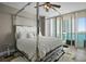 Comfortable primary bedroom featuring a canopy bed and view of the water at 231 Riverside Dr # 708, Daytona Beach, FL 32117