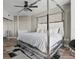 Well-appointed primary bedroom featuring a canopy bed, sliding glass closet, and water views at 231 Riverside Dr # 708, Daytona Beach, FL 32117