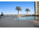 A refreshing pool with lounge chairs, umbrellas, and palm trees, offering a serene waterfront setting at 231 Riverside Dr # 708, Daytona Beach, FL 32117