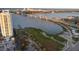 A high-rise condo building sits on the waterfront with a bridge and a cityscape in the background at 231 Riverside Dr # 708, Daytona Beach, FL 32117