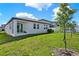 The spacious backyard features lush green grass, a small patio, and provides ample space for outdoor activities and entertainment at 2311 Bear Peak Road, Minneola, FL 34715
