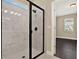 Modern bathroom featuring a stylish shower with a glass enclosure and elegant marble tile, creating a spa-like experience at 2311 Bear Peak Road, Minneola, FL 34715