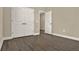 Empty bedroom with dark wood flooring and a double door closet at 2311 Bear Peak Road, Minneola, FL 34715