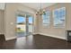Cozy dining area featuring a modern chandelier and sliding glass doors at 2311 Bear Peak Road, Minneola, FL 34715