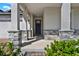 Inviting front porch with stone-clad columns and a view of the home's entrance at 2311 Bear Peak Road, Minneola, FL 34715