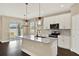 Bright kitchen with a large island, stainless steel appliances, and sliding glass doors to the backyard at 2311 Bear Peak Road, Minneola, FL 34715