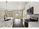 Well-lit kitchen with a central island, stainless steel appliances, and view of the backyard at 2311 Bear Peak Road, Minneola, FL 34715