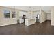 Open-concept living space featuring a modern kitchen island and stainless steel appliances at 2311 Bear Peak Road, Minneola, FL 34715