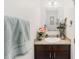 Cozy powder room with dark wood vanity, granite countertop, and decorative accents at 233 Primrose Dr, Davenport, FL 33837