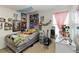 Eclectic bedroom featuring a variety of decorations and posters with window, guitar, and bed at 233 Primrose Dr, Davenport, FL 33837