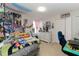 Eclectic bedroom features posters, a bed, a desk, and storage at 233 Primrose Dr, Davenport, FL 33837