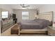 Cozy bedroom features a ceiling fan, large window, and decorative furniture at 233 Primrose Dr, Davenport, FL 33837