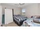 Modest bedroom with two twin beds, window, ceiling fan, and carpet at 233 Primrose Dr, Davenport, FL 33837