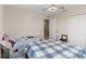 Modest bedroom features two twin beds, a ceiling fan, and a closet at 233 Primrose Dr, Davenport, FL 33837