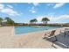 Large community pool with lounge chairs and palm trees on a sunny day at 233 Primrose Dr, Davenport, FL 33837