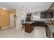 Spacious kitchen featuring granite countertops, stainless steel appliances and a convenient center island at 233 Primrose Dr, Davenport, FL 33837