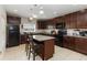 Modern kitchen featuring granite countertops, stainless steel appliances, and a center island with seating at 233 Primrose Dr, Davenport, FL 33837