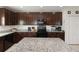 Well-appointed kitchen features granite countertops, black appliances, ample cabinet space, and a central island at 233 Primrose Dr, Davenport, FL 33837