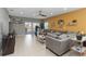 Bright living room features tile flooring, ceiling fan and sliding glass doors for seamless indoor-outdoor living at 233 Primrose Dr, Davenport, FL 33837