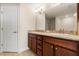 Bathroom with double sink, granite countertops and wood cabinets at 2412 Twin Lake View Rd, Winter Haven, FL 33881