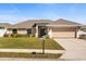 Charming single-story home with well-maintained lawn, beige exterior, and a two-car garage, offering curb appeal at 2412 Twin Lake View Rd, Winter Haven, FL 33881