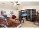 Comfortable living room with tile flooring, ceiling fan, large entertainment center, and cozy furnishings at 2412 Twin Lake View Rd, Winter Haven, FL 33881