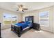 Serene main bedroom featuring natural light, comfortable bed, ceiling fan, and neutral decor at 2412 Twin Lake View Rd, Winter Haven, FL 33881