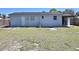 Back exterior view of home with a large backyard, patio, and outdoor seating area at 2480 Alamanda Ave, Deltona, FL 32738