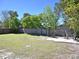 Large, grassy backyard featuring a patio and seating area for outdoor enjoyment at 2480 Alamanda Ave, Deltona, FL 32738