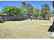 Spacious backyard with a well-maintained lawn, providing ample space for outdoor activities at 2480 Alamanda Ave, Deltona, FL 32738