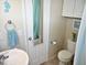 Bathroom featuring a vessel sink, white cabinets, and coordinated accessories at 2480 Alamanda Ave, Deltona, FL 32738