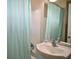 Functional bathroom featuring a shower with a blue curtain and a single sink vanity at 2480 Alamanda Ave, Deltona, FL 32738